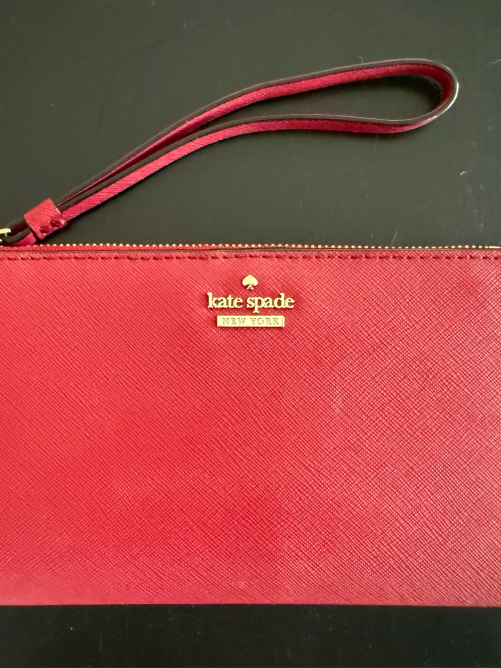 kate spade red saffiano wristlet with gold logo